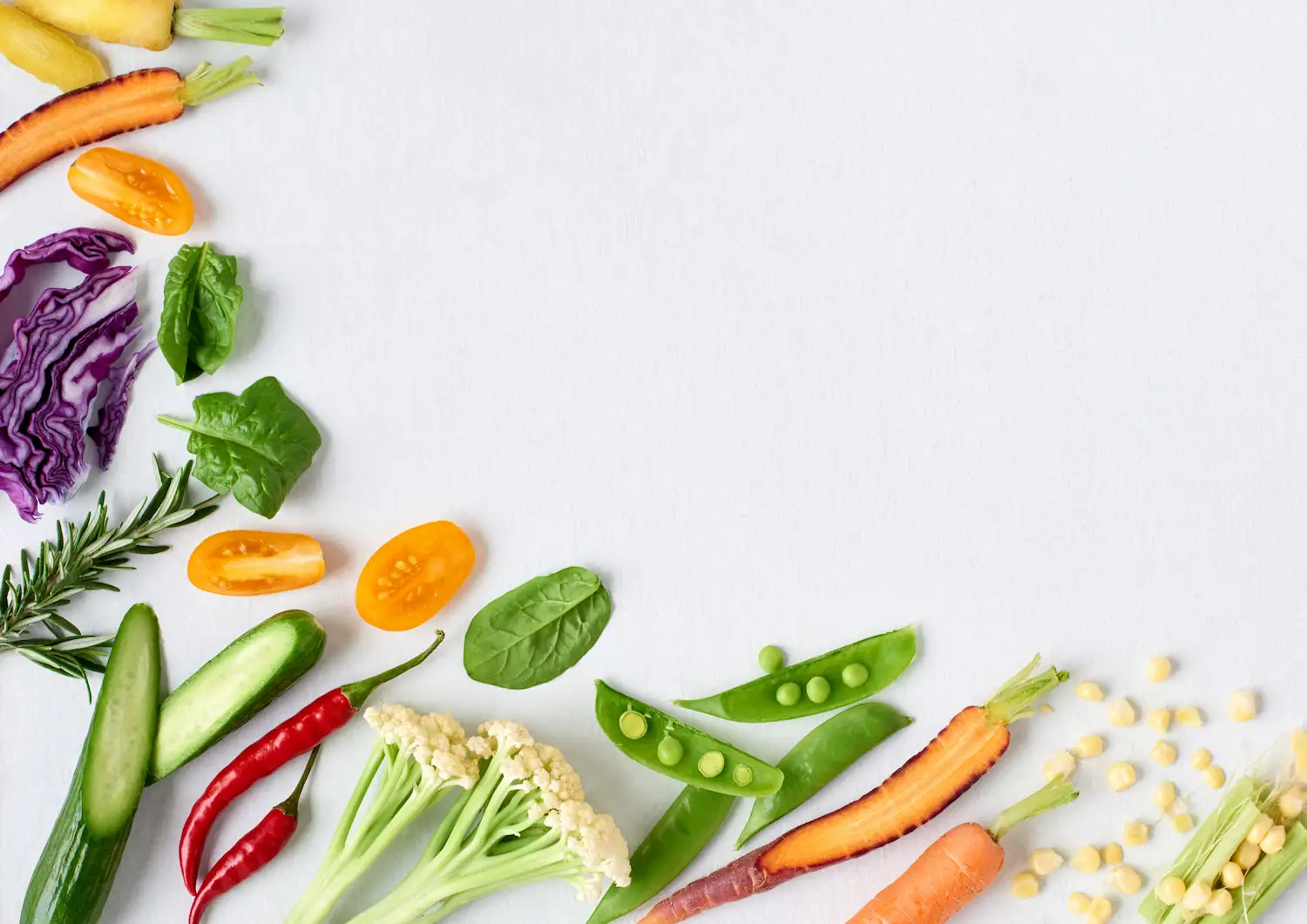 fresh vegetables scattered on one side of the page